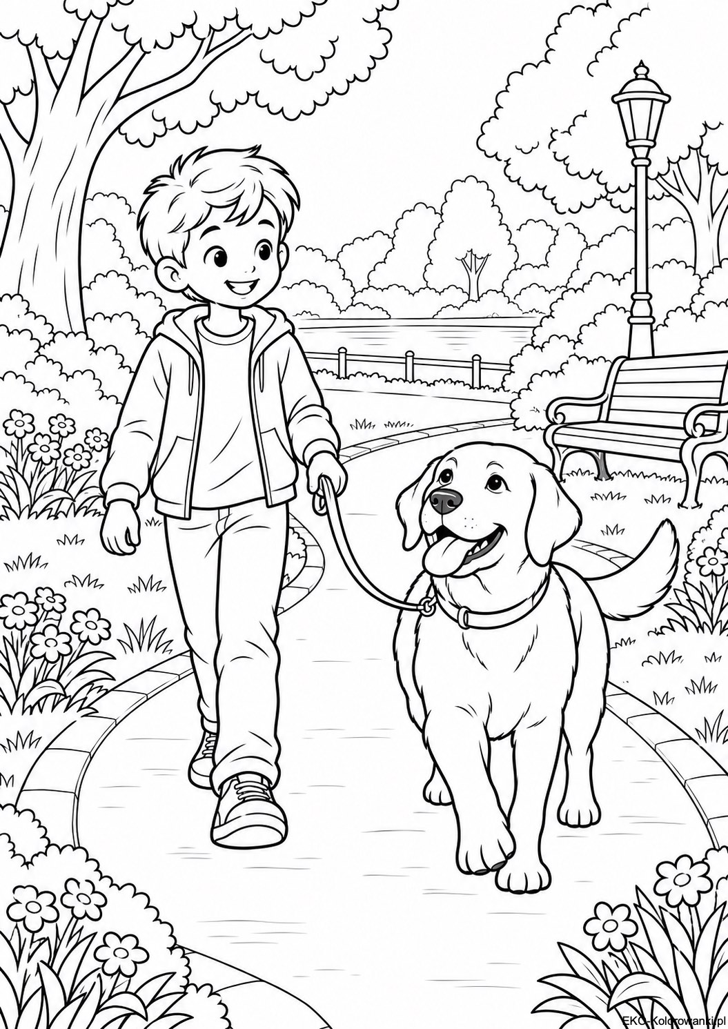 Chlopiec z labradorem na spacerze w parku